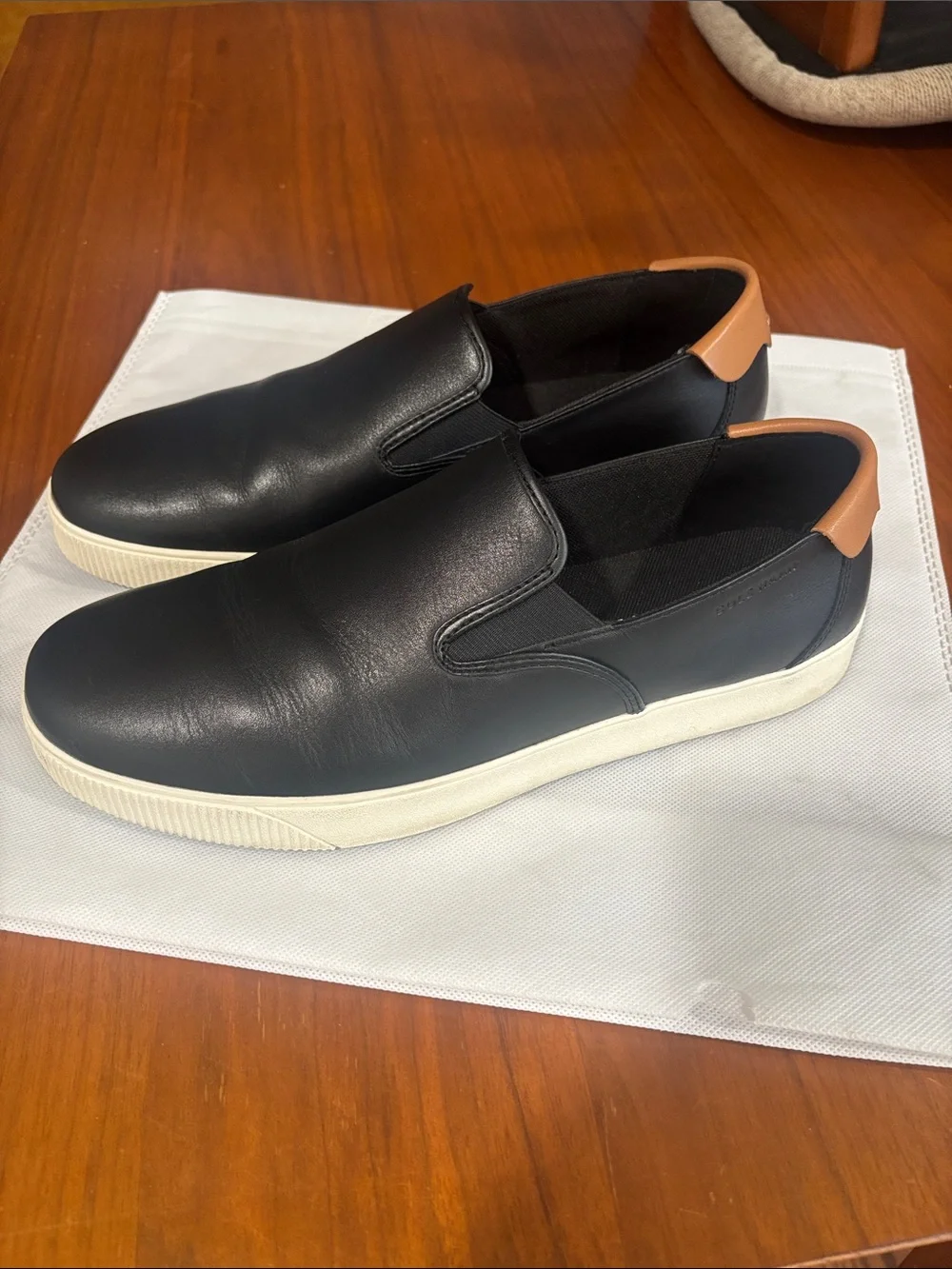 Cole Haan Black Leather Slip-On Sneakers with Tan Heel Tab